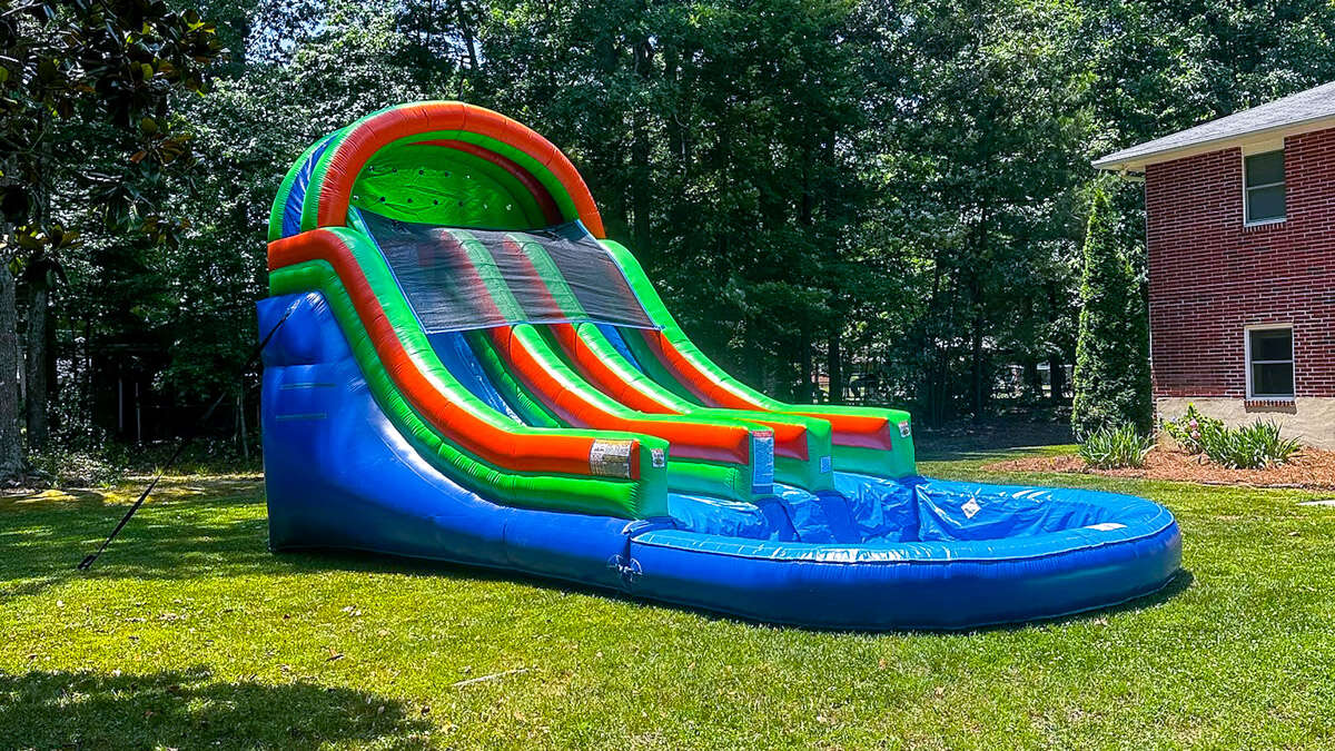 Inflatable water slide rental set up in a backyard in Hampton Roads