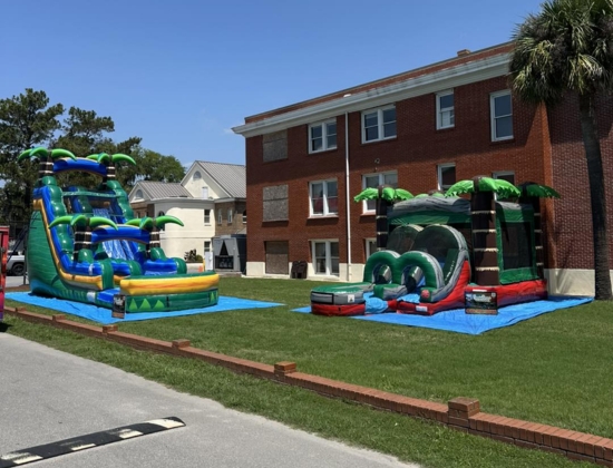 Boomin Bounce, LLC water slide and bounce house setup at an outdoor event