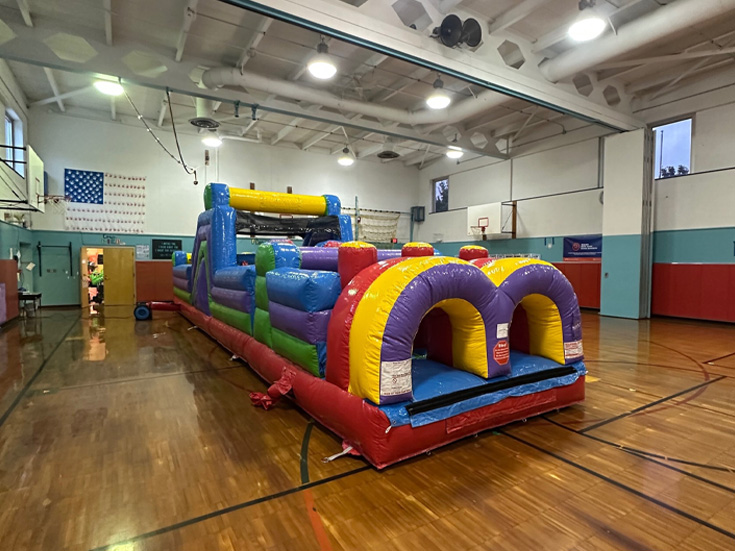 School event with bounce houses and inflatables