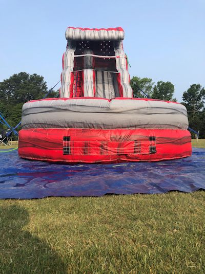 Front view of the 22 water slide with attached pool designed to look like lava red and rock grey.