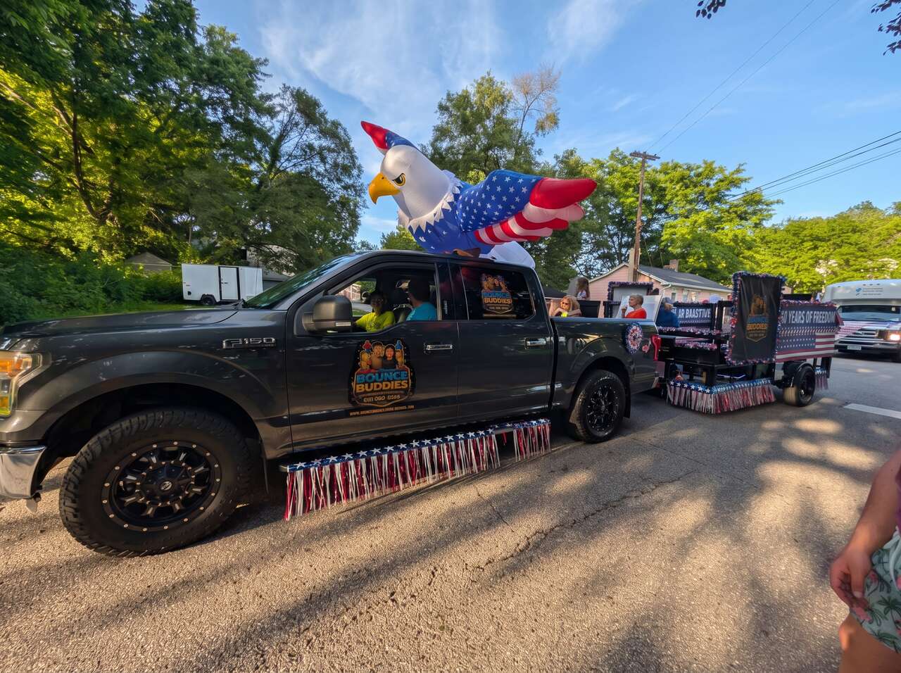Bounce Buddies truck with a giant inflatable eagle in a Milford, Ohio parade