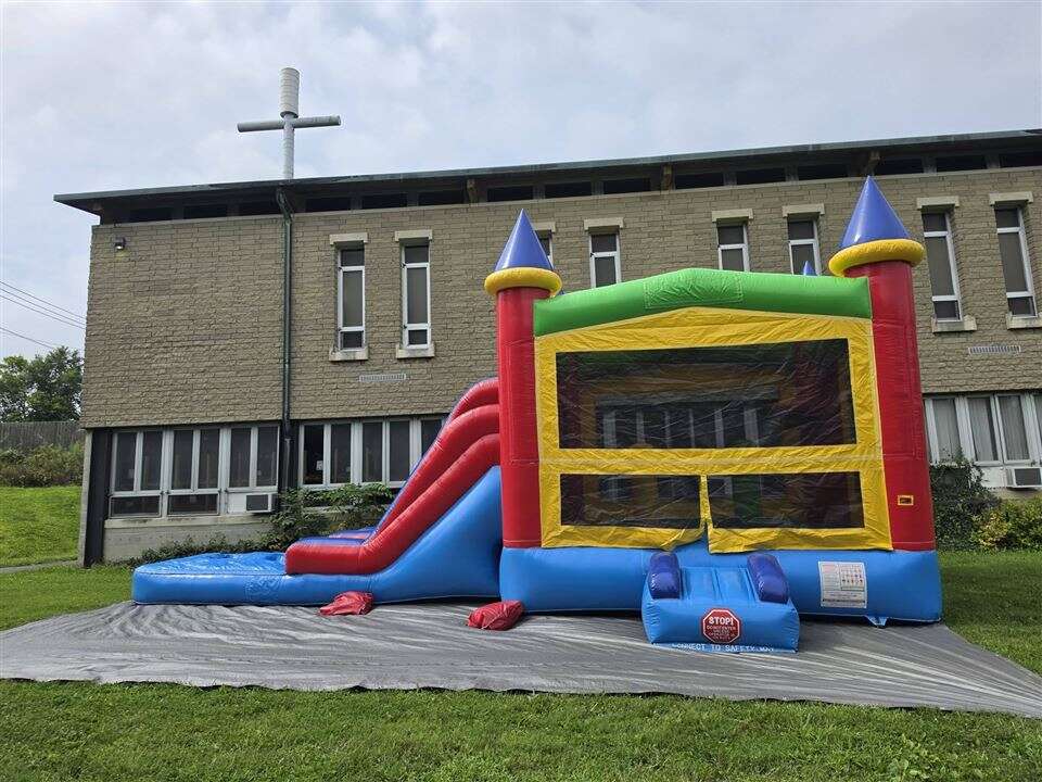 Castle bounce house combo with slide set up on the lawn at Clough United Methodist Church in Anderson Township