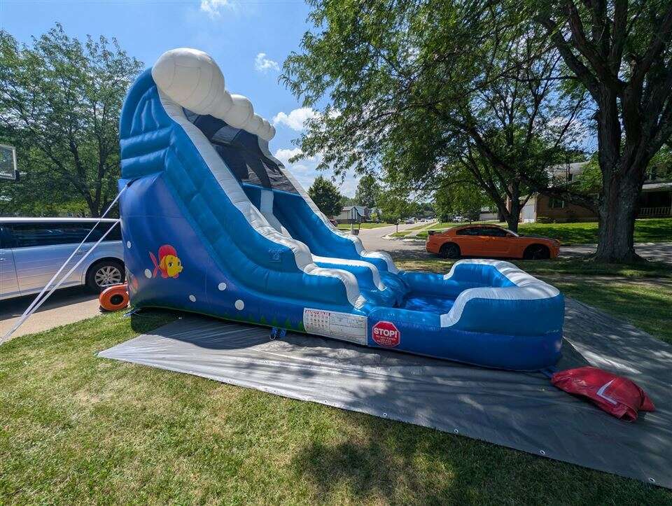 Blue and white Ocean inflatable slide set up in a front yard in Fairfield, Ohio