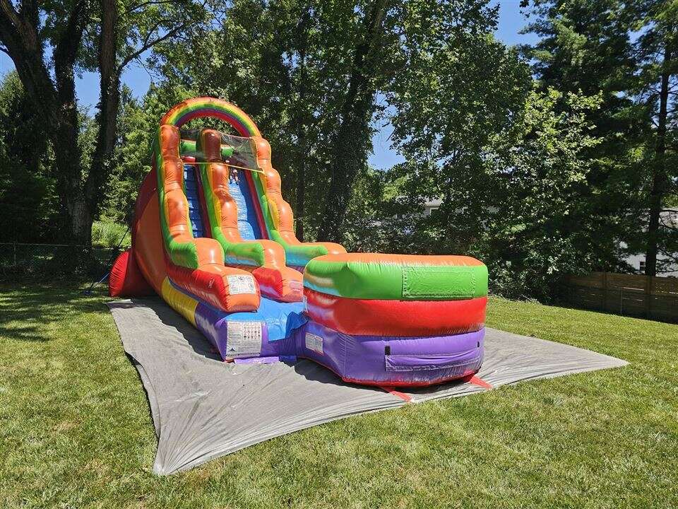 Rainbow inflatable water slide set up in a backyard in Loveland, Ohio
