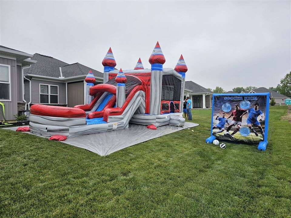 Titanium dual lane bounce house combo and inflatable soccer game set up in a backyard in Mason, Ohio