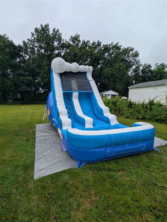 Blue and white Ocean inflatable water slide set up in a backyard in Withamsville near Eastgate, Ohio