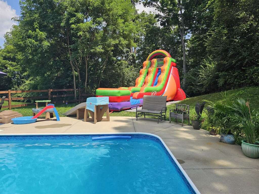 Inflatable water slide set up next to a backyard pool in Bethel, Ohio