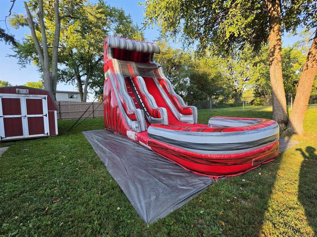Red marble inflatable water slide set up in a backyard near Delhi, Ohio