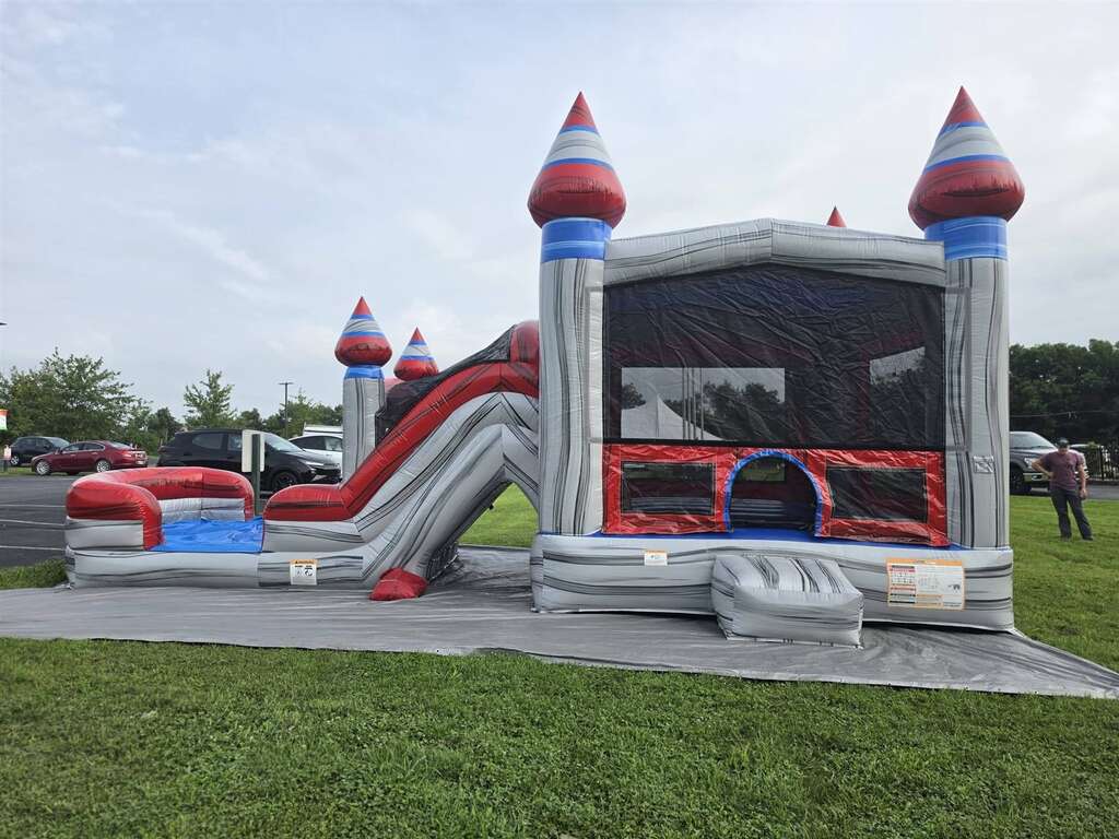 Castle bounce house combo with slide set up for a community event near Eastgate, Ohio