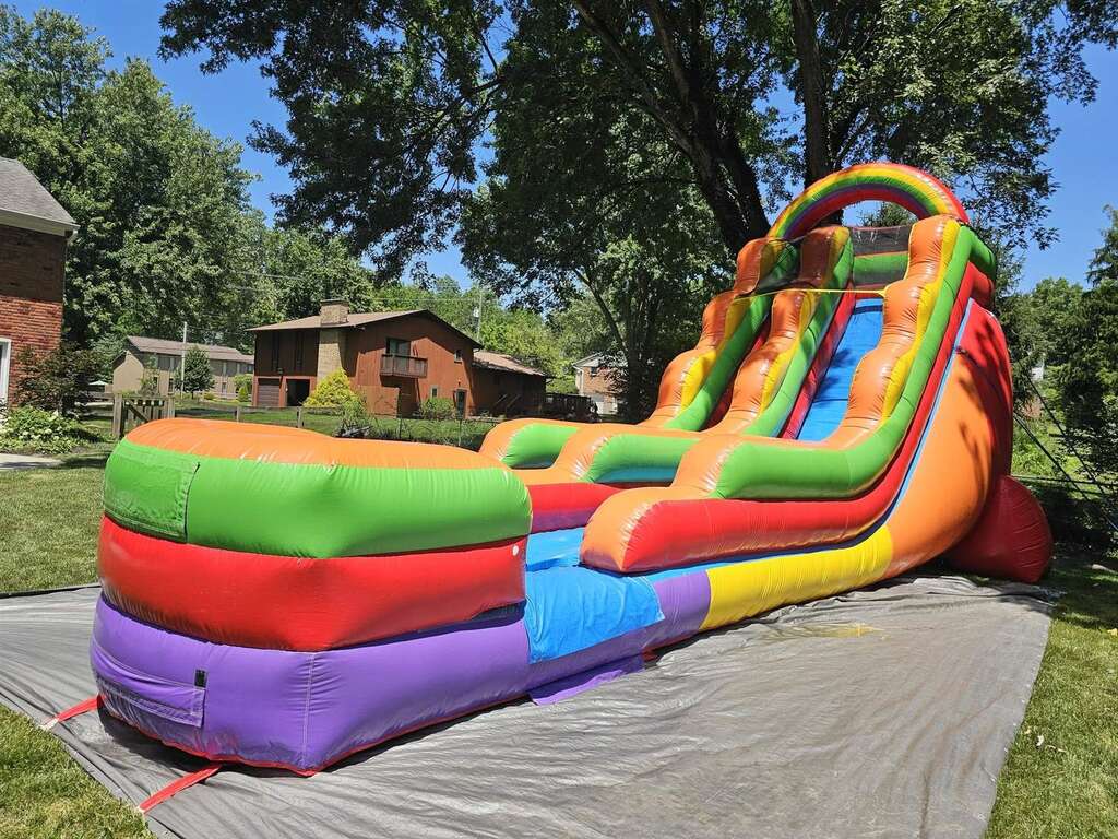 Rainbow inflatable water slide set up in a backyard in Loveland, Ohio