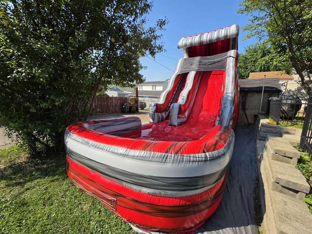 Red marble inflatable water slide set up for a backyard party in Newport, Kentucky