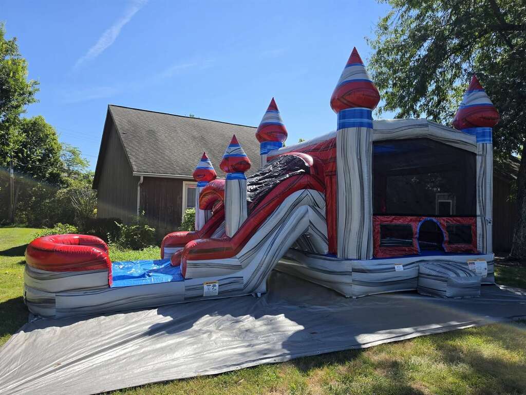 Silver castle bounce house and slide combo set up in West Chester, Ohio