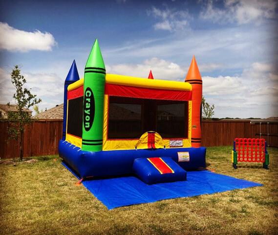 15' X 15' Inflatable crayon bounce house on grass in backyard with giant 4 to score game.