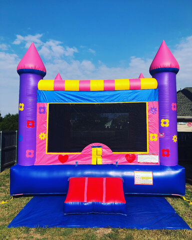 15' X 15' Pink and purple princess bounce house on grass in backyard for party.