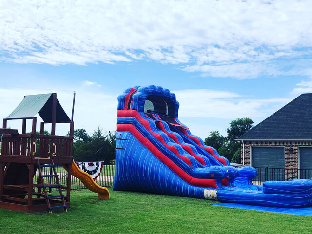 15-foot inflatable red white and blue water slide with pool on grass