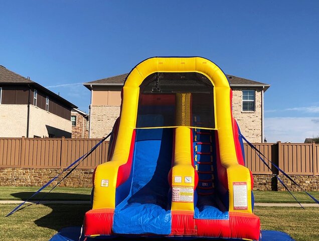 16-foot inflatable dry slide on grass at a school event