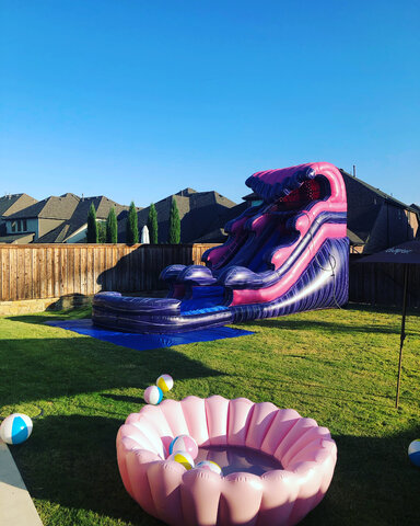 15-foot purple and pink inflatable water slide with pool on grass