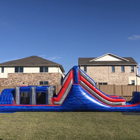 40-foot blue rush obstacle course on grass for school event in Prosper Texas.