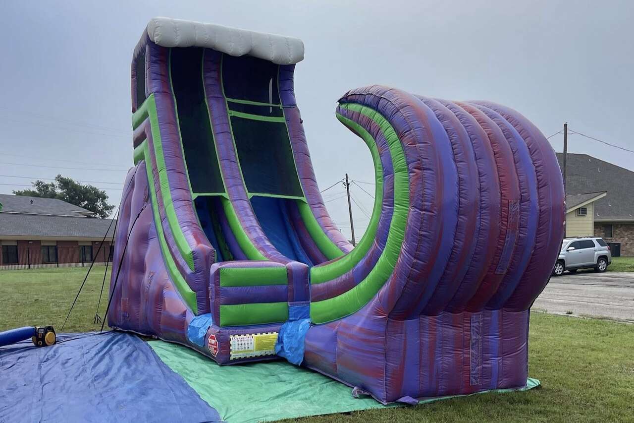 Kids enjoying water slide at an Pecan Hill party