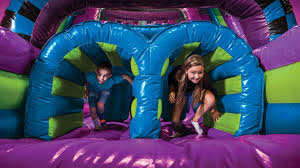 Kids on inflatable water slide in Pecan Hill TX