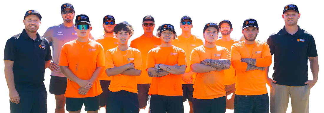 The Bounce Party of Tampa crew, twelve people in company shirts and caps, standing together arms crossed and smiling