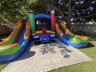 Sports-Themed Bounce House with Dual Slides 