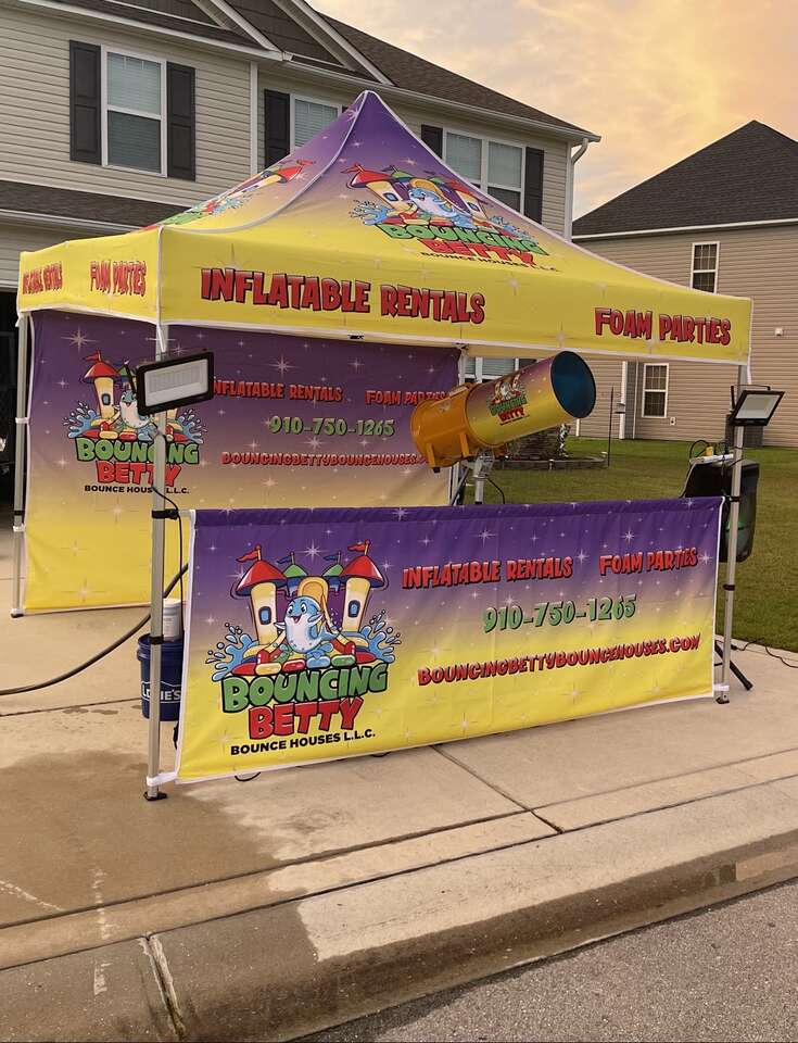 Bouncing Betty Bounce Houses company branded pop up tent and foam cannon