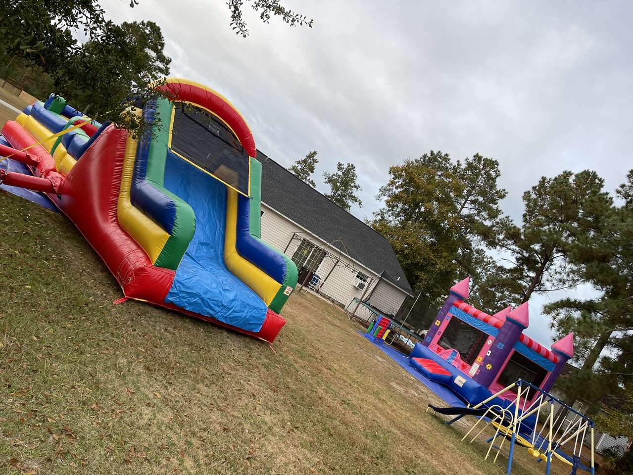 Obstacle Course inflatable next to a princess castle bounce house