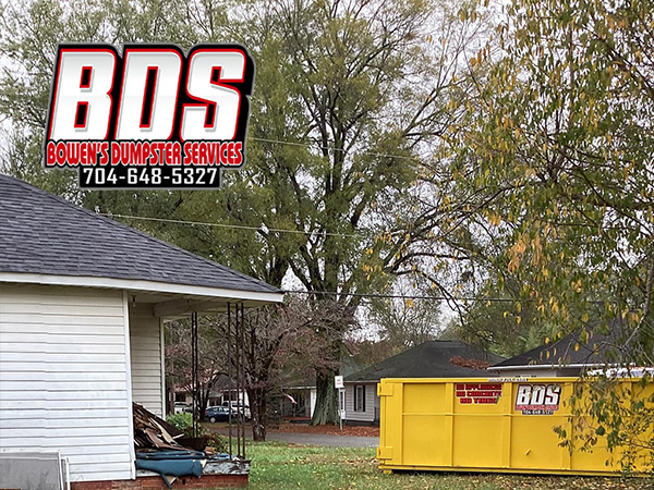 Empty Bowen's Dumpster Services container positioned ready for use on a residential driveway.