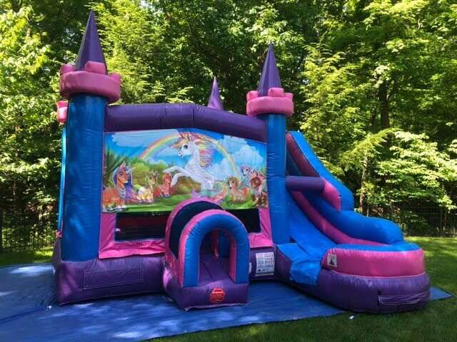 kids jumping in a bounce house smiling