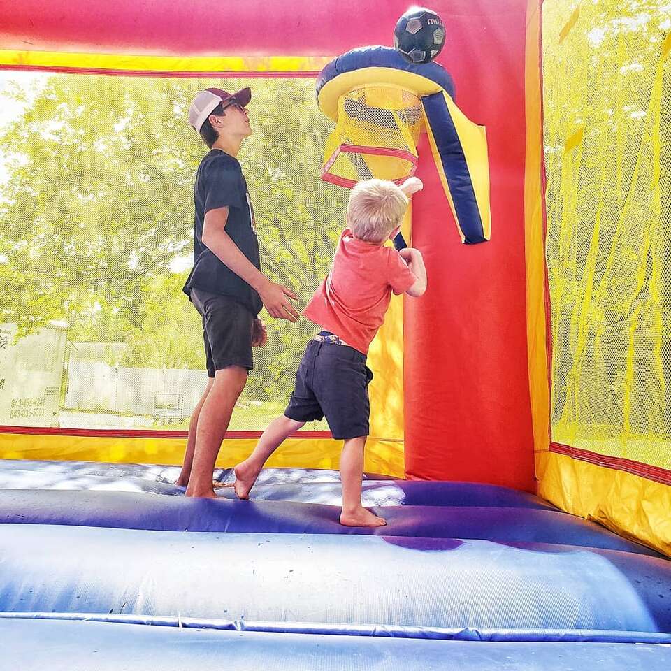 Children having fun and smiling playing on a waterslide