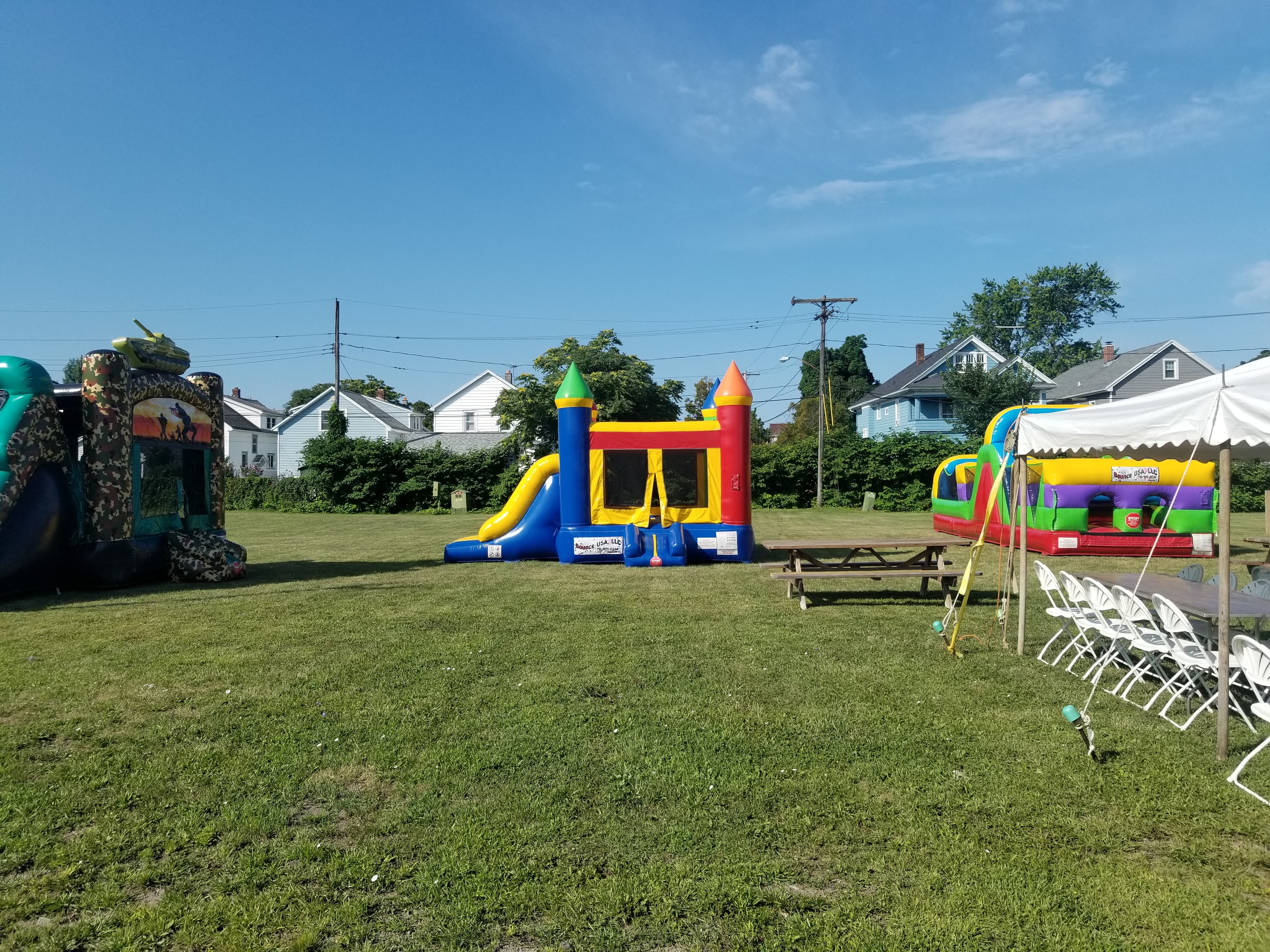 2 bounce houses with slides and an obstacle course rented for a baseball league party