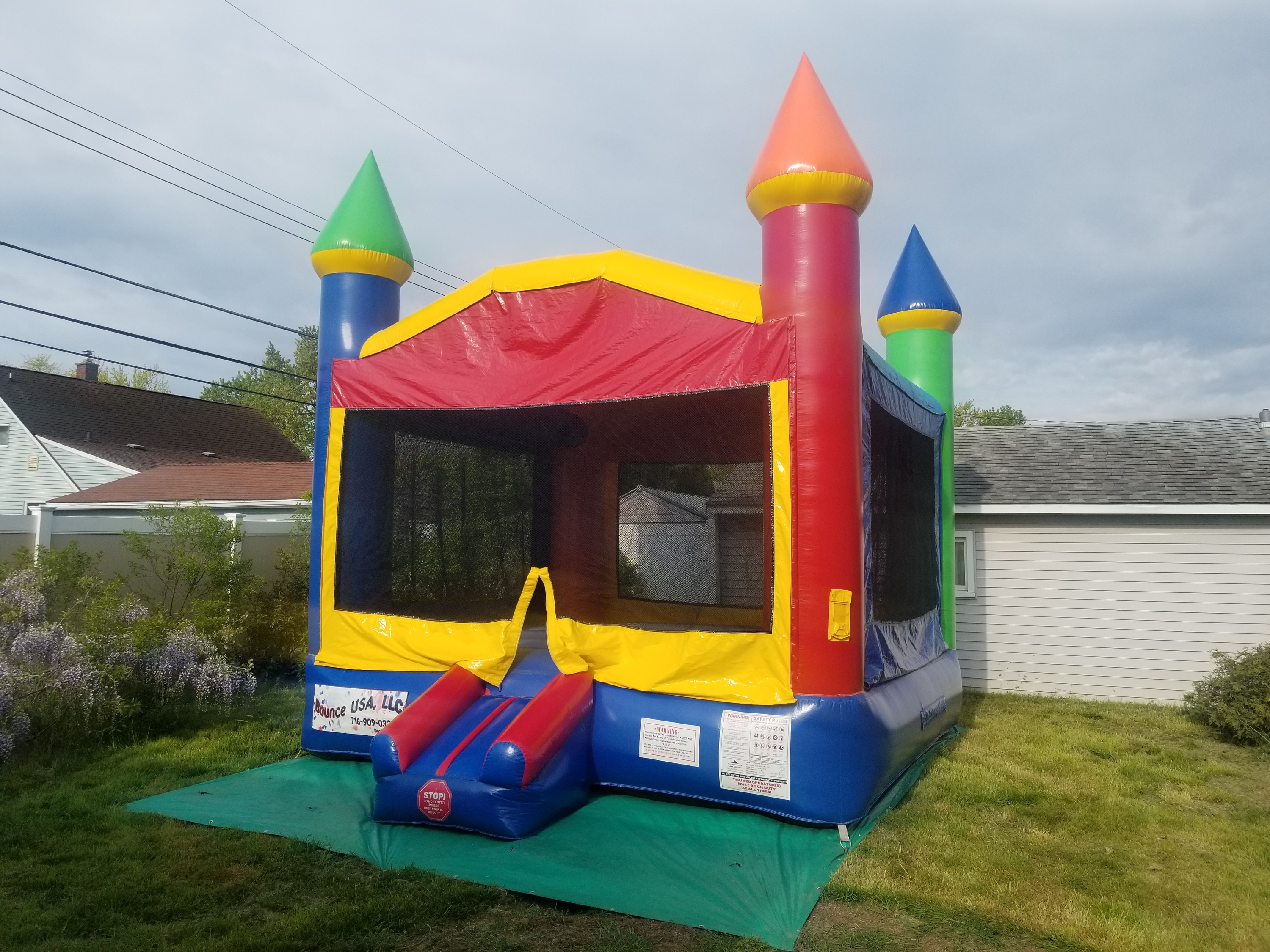 Unisex castle bounce house that was rented for a 6 year old birthday party