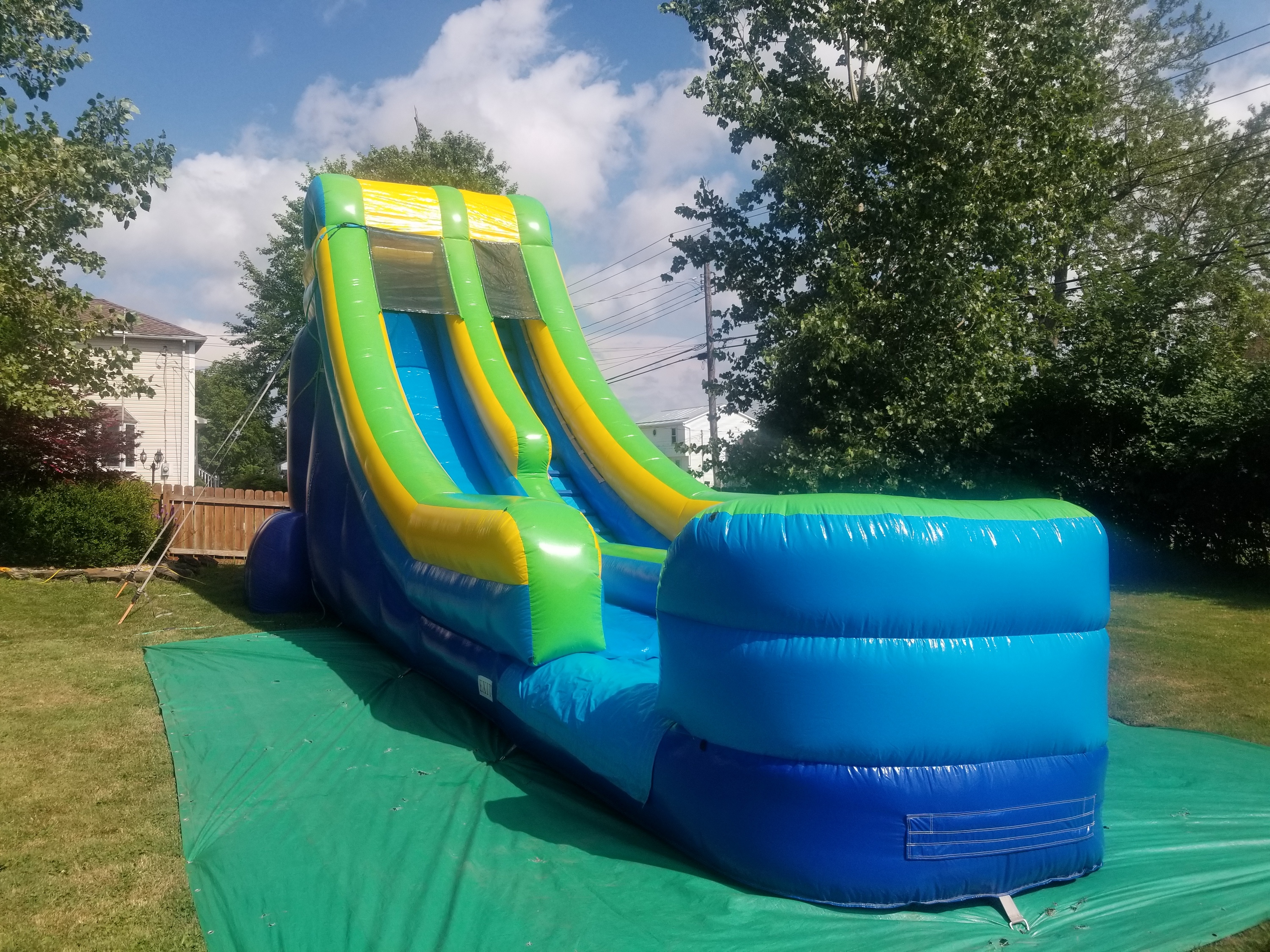 18 foot tall blue, yellow and green water slide 