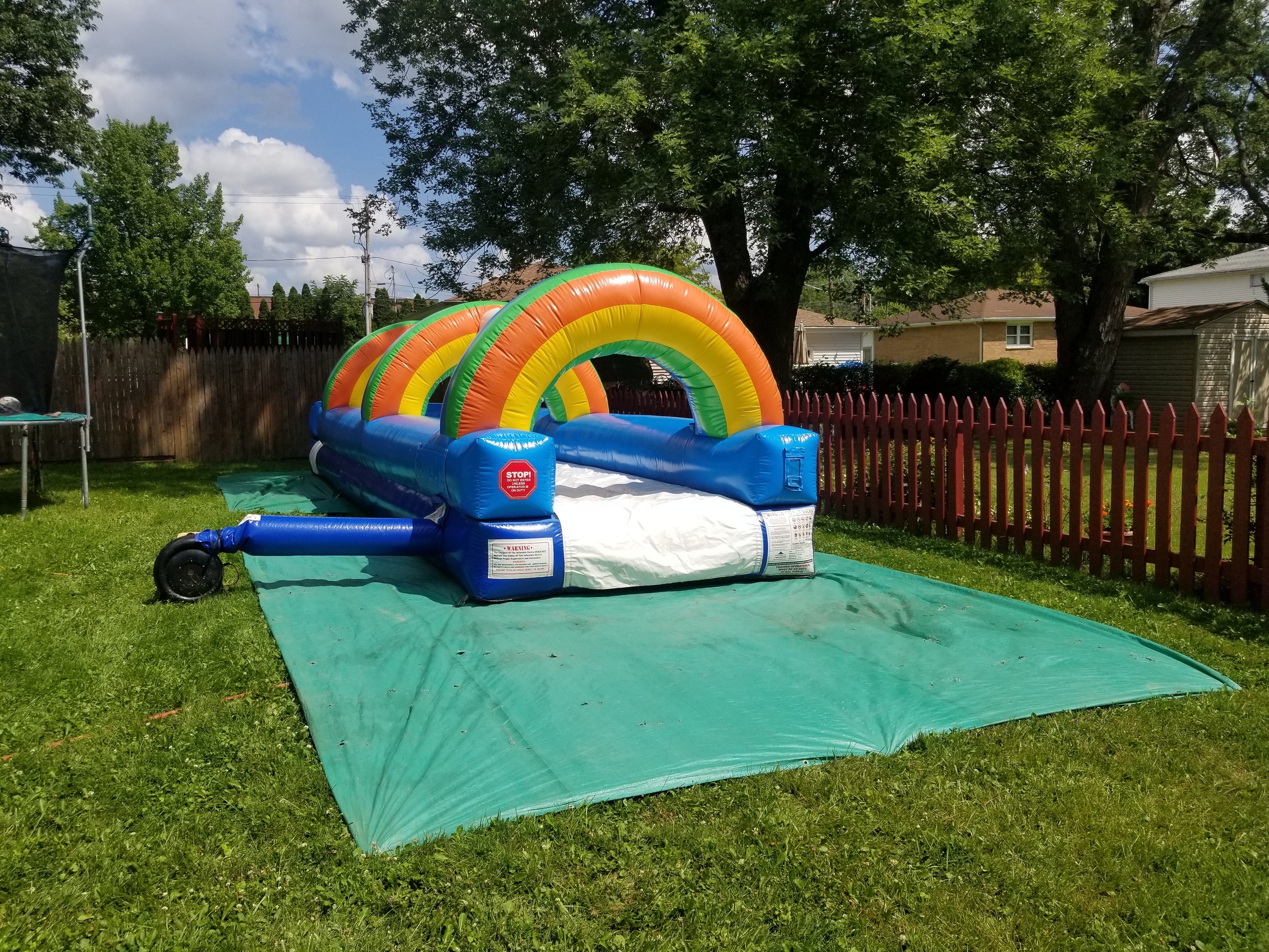 Rainbow arched 30 foot long slip and slide rental for a high school graduation party