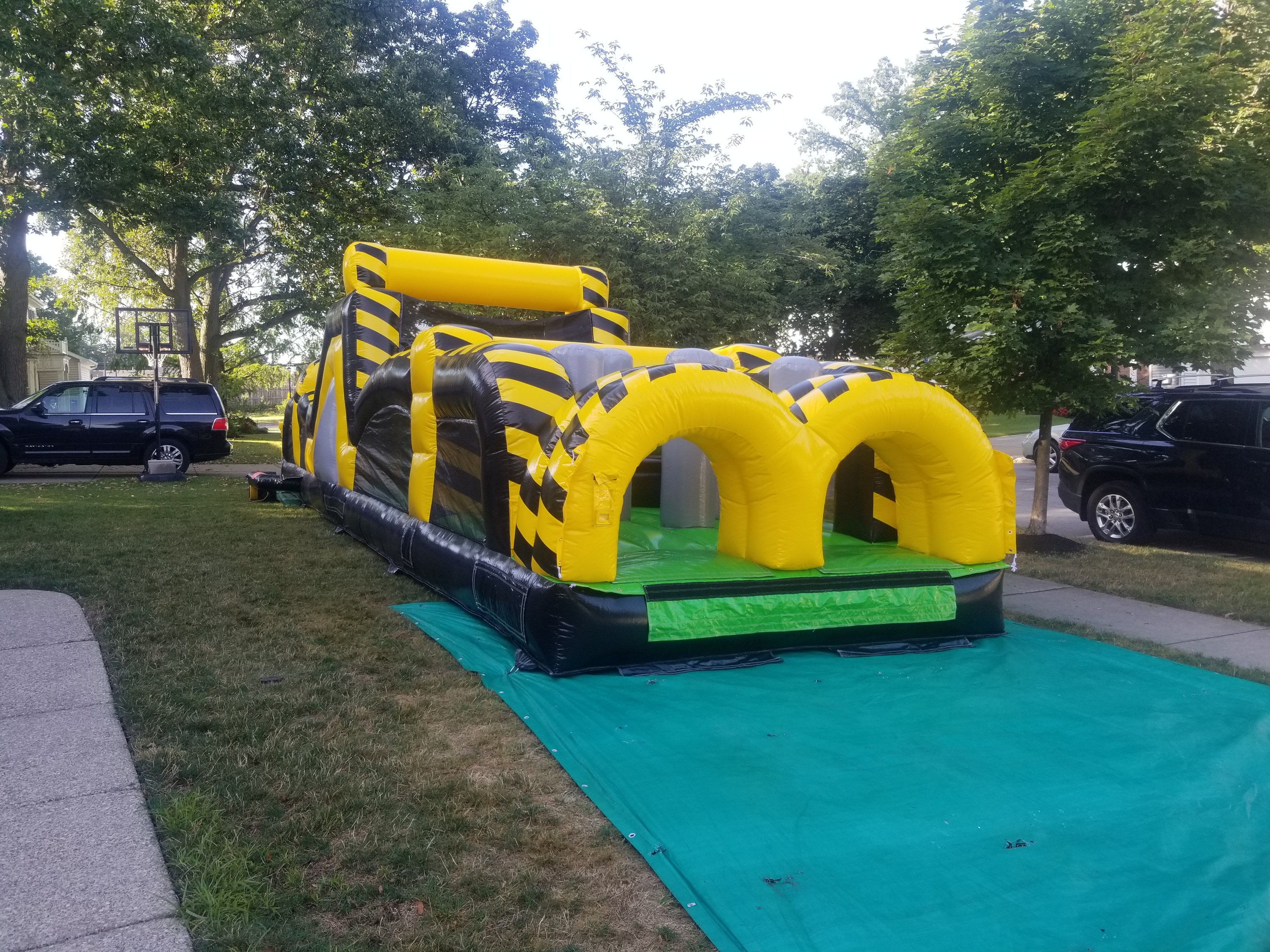 40 foot long yellow obstacle course set up on the front yard of a town of Tonawanda home