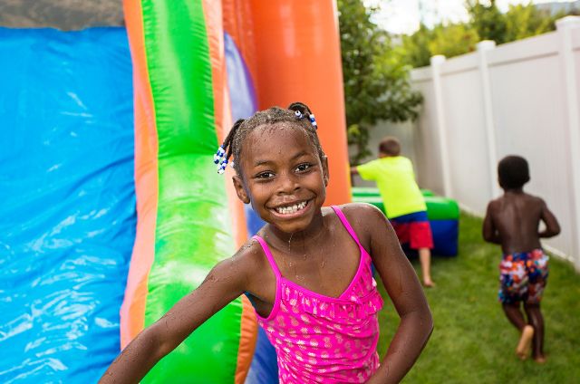 Kids enjoying water slide at large event