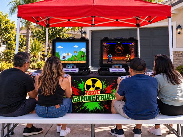 Adults playing classic SNES Retro Gaming Station under red canopy in Southern California