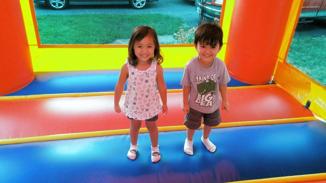 Two smiling kids playing inside a colorful bounce house in Boardman, OH Two smiling kids playing inside a colorful bounce house in Boardman, OH