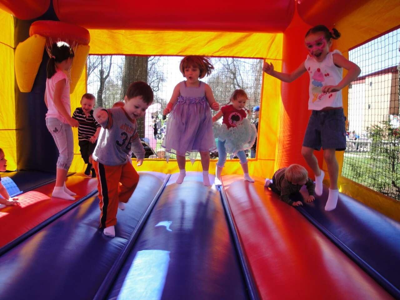 Kids jumping and playing inside a colorful bounce house rental in Youngstown, OH Kids jumping and playing inside a colorful bounce house rental in Youngstown, OH