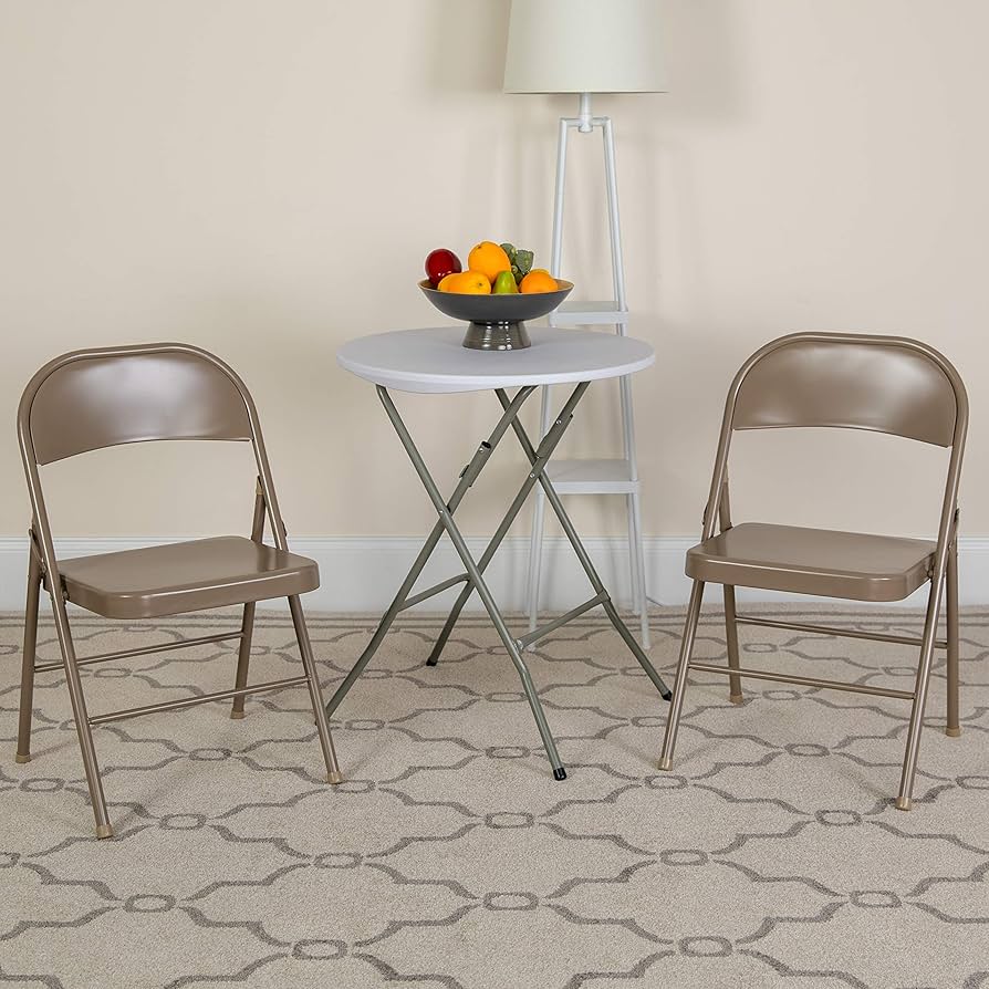 Tan metal folding chairs with a small round table set up indoors in Youngstown, OH, perfect for casual events, meetings, and gatherings