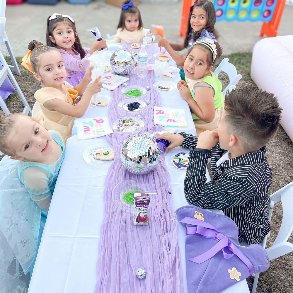 Table and chair rentals in Boardman, OH under a white event tent from Confetti House Rentals.