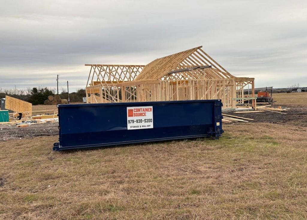 Container Source Storage & Roll Off dumpster placed at a residential construction site