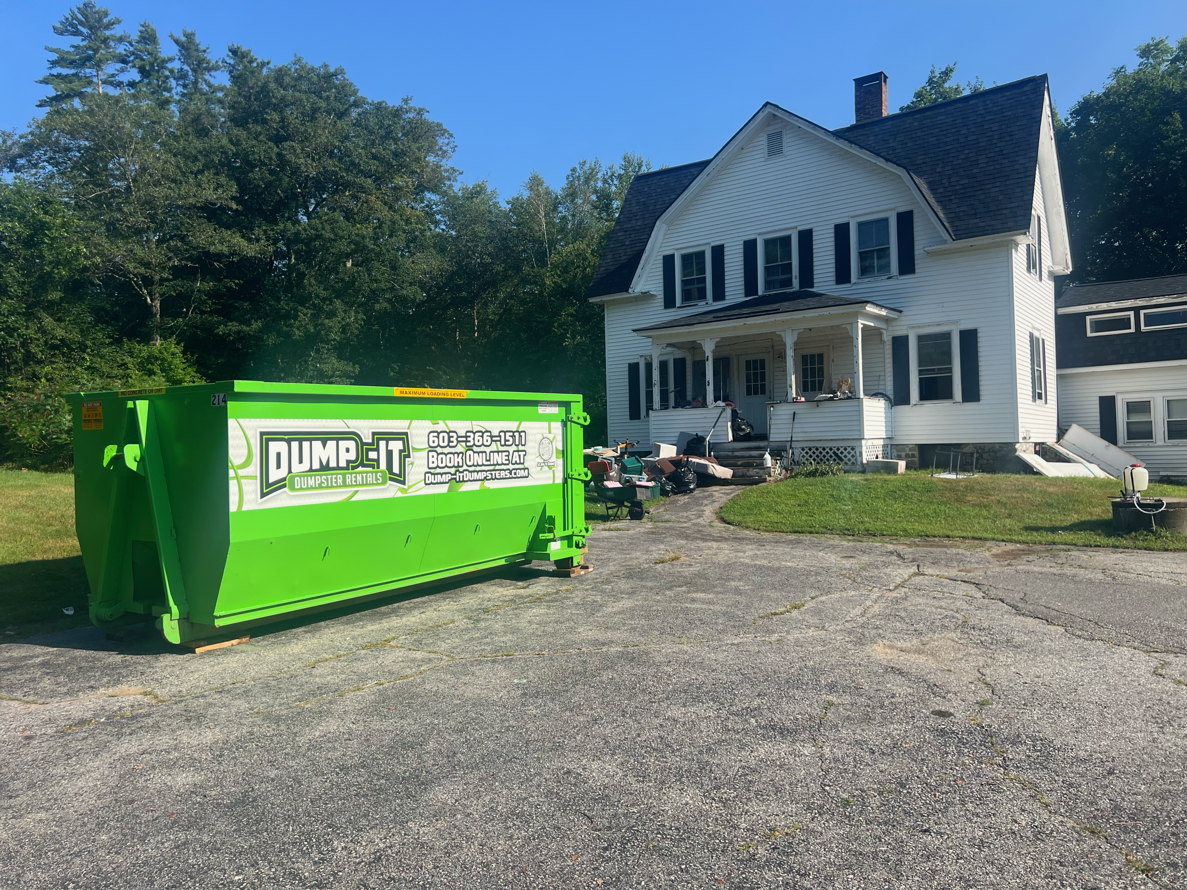 Dumpster from Dump-It Dumpster Rentals positioned on a sidewalk