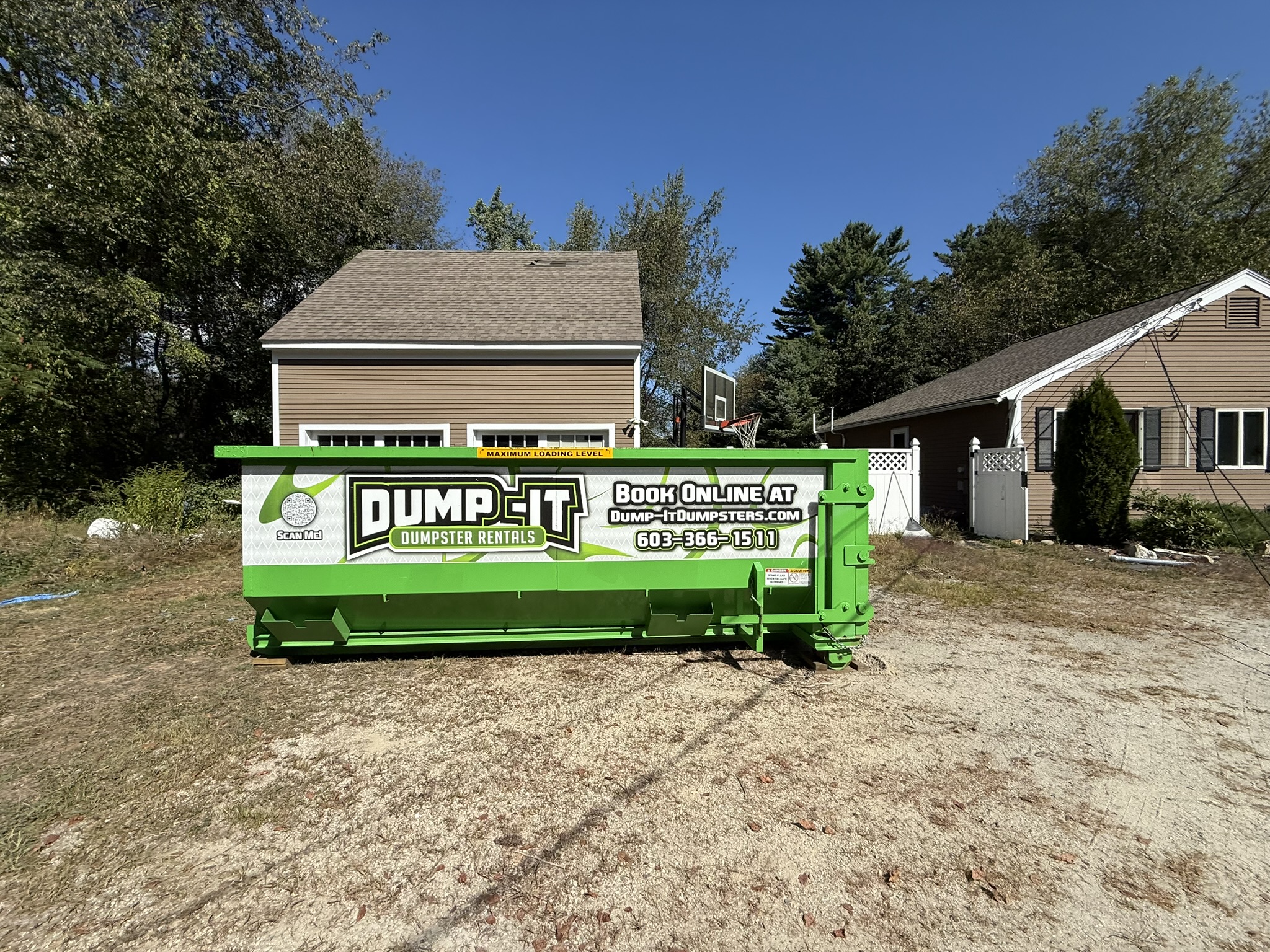 Dump-It Dumpster Rentals" logo over a green dumpster in a driveway.