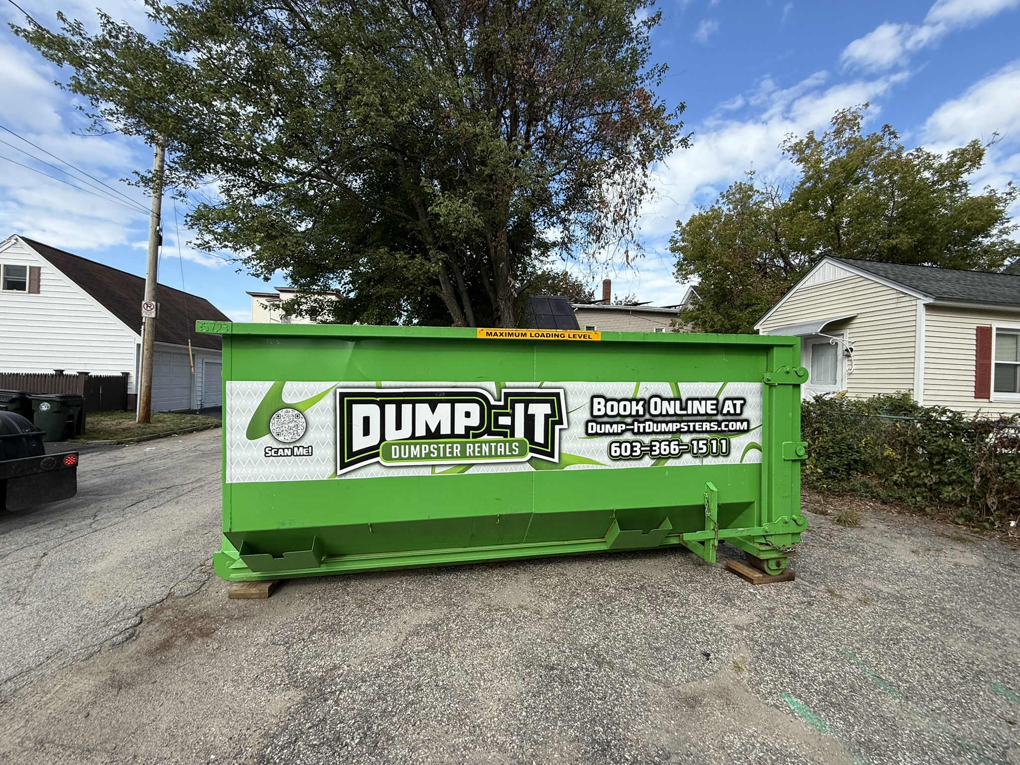 Dump-It Dumpster Rentals" logo over a construction site