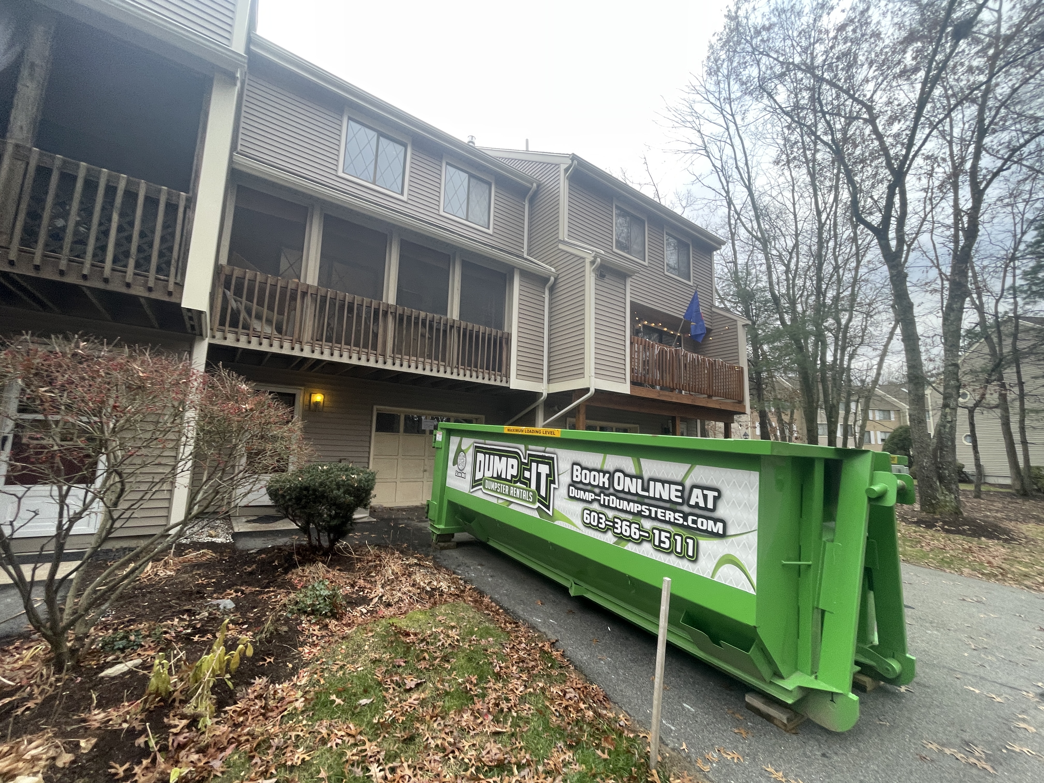 Dump-It Dumpster Rentals" logo over a construction site