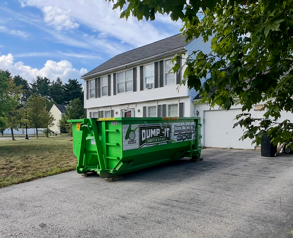 Dumpster from Dump-It Dumpster Rentals positioned on a sidewalk