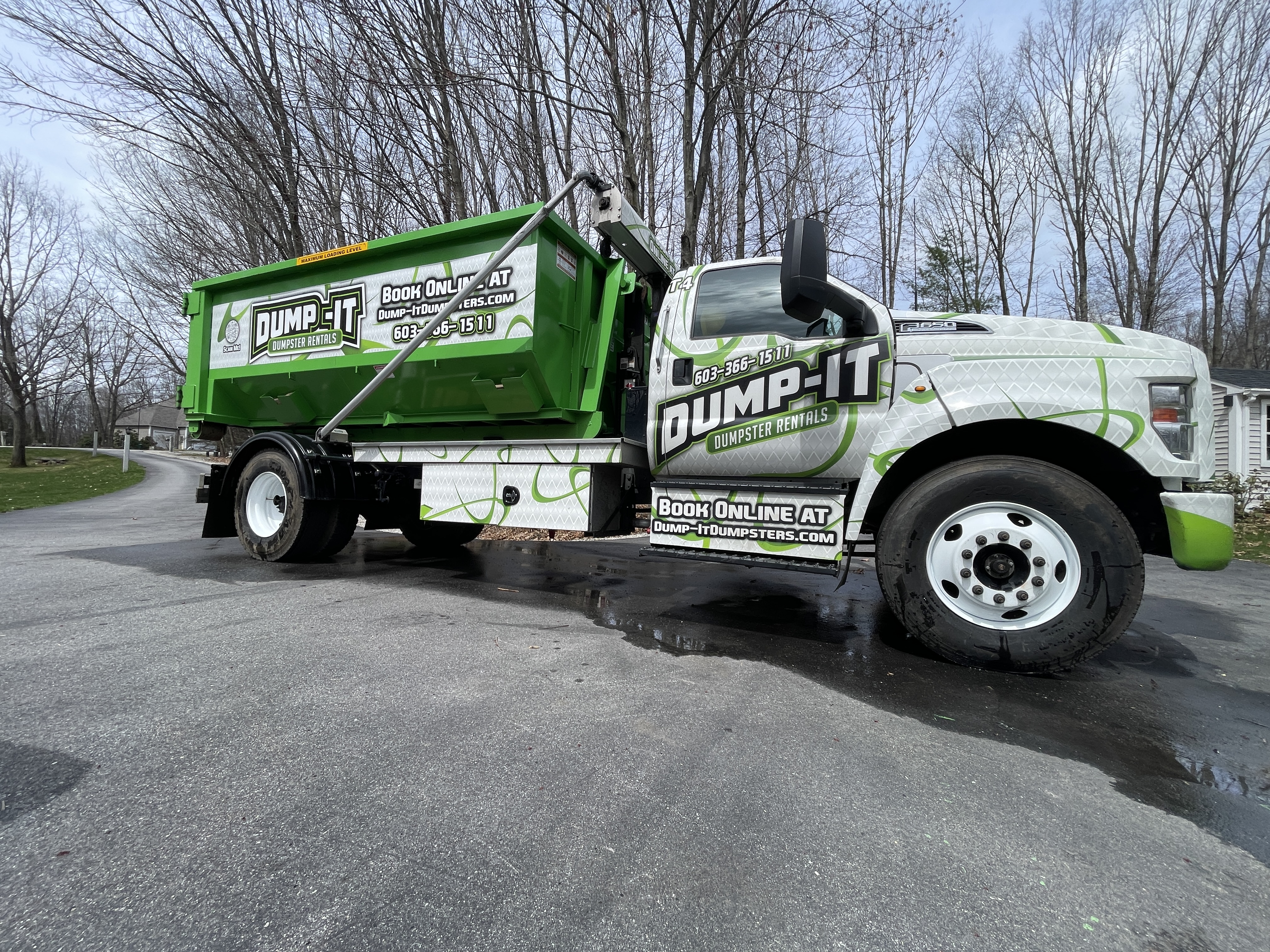 Residential dumpster from Dump-It Dumpster Rentals placed in a backyard