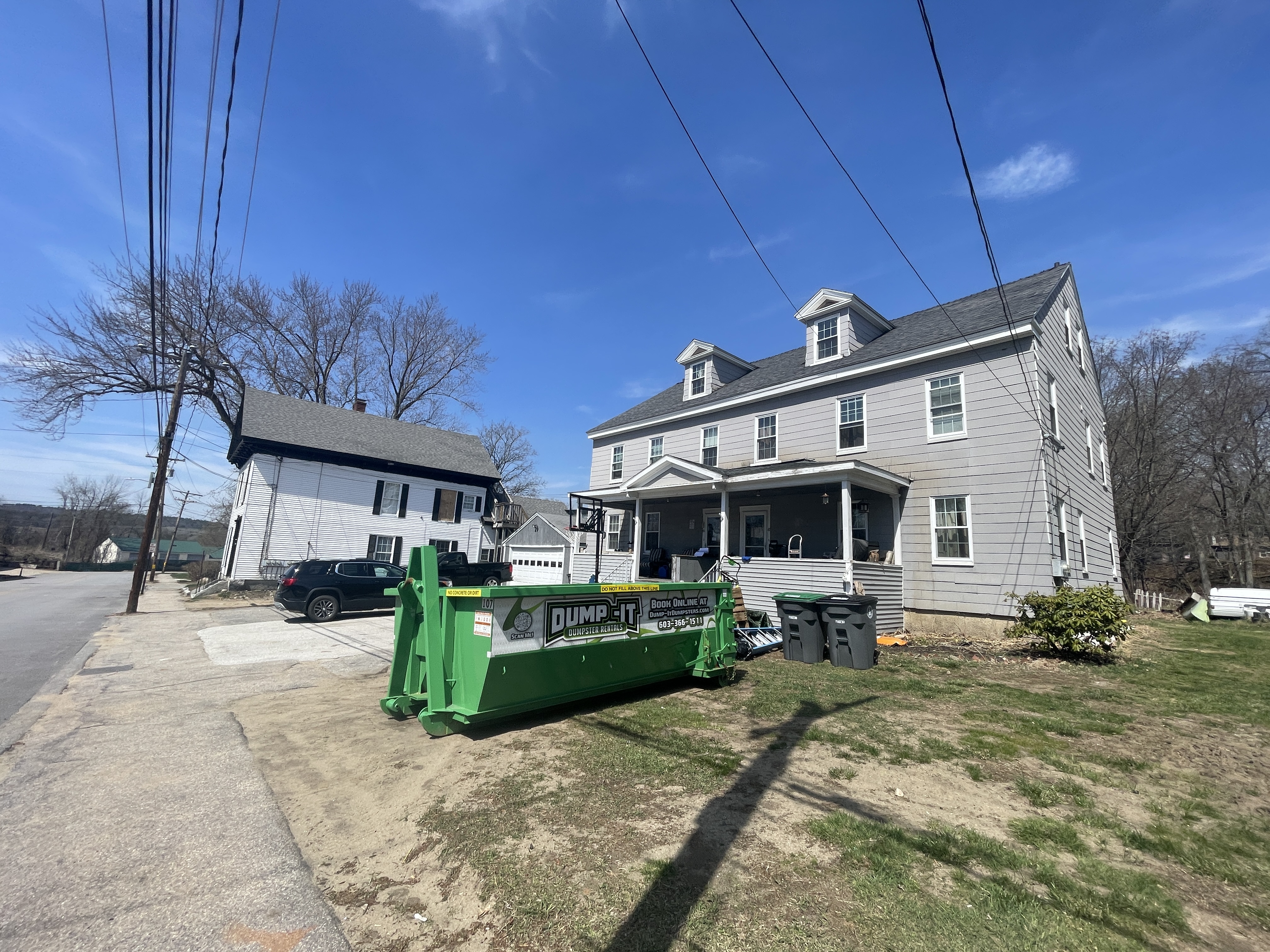 Two dumpsters from Dump-It Dumpster Rentals side by side